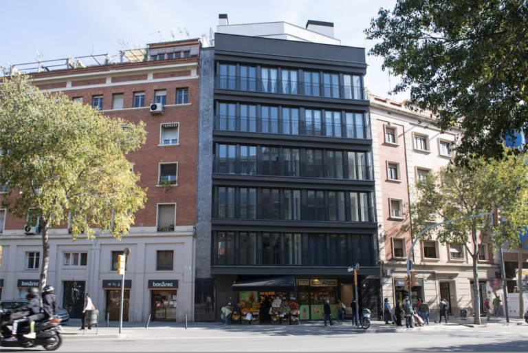 A building with many windows on the side of it.