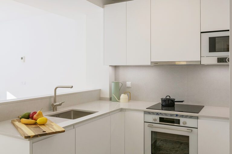 Modern kitchen with fruits and appliances.