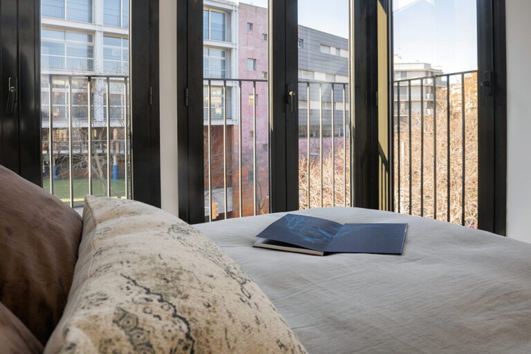 Cozy bedroom with open balcony view.