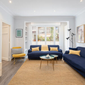 Cozy living room with blue sofas and decor.