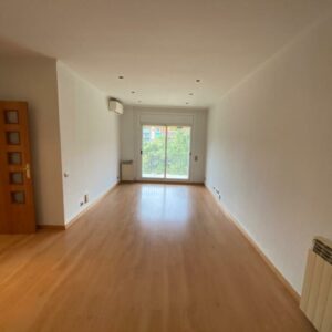 Empty room with wooden floor and window.