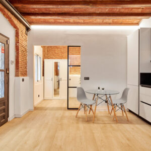 Modern dining area with glass table.