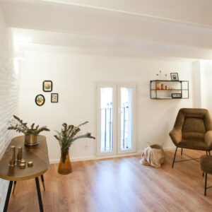 Modern living room with plants and decor.
