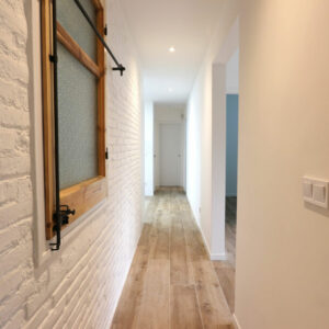 Stylish hallway with wooden accents and lighting.