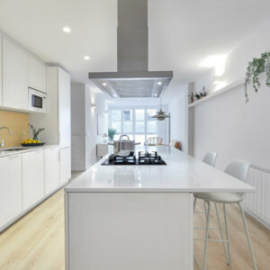 Modern kitchen with white cabinetry and island.